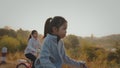 Sibling asian girls riding a bicycle and enjoying with nature together with sunrise in the morning time.