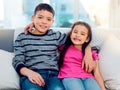 Sibling love at an all time high. Portrait of two adorable young siblings posing with their arms around each other while Royalty Free Stock Photo