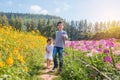 Sibling walking in flower park Royalty Free Stock Photo