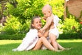 Siblings with angel wings playing on green grass Royalty Free Stock Photo