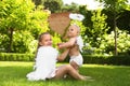 Siblings with angel wings playing on green grass Royalty Free Stock Photo