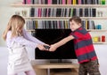 Siblings arguing over the remote control in the living room in f Royalty Free Stock Photo