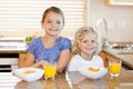 Siblings with breakfast behind the kitchen counter Royalty Free Stock Photo