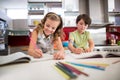 Siblings doing homework in kitchen Royalty Free Stock Photo