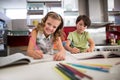 Siblings doing homework in kitchen Royalty Free Stock Photo