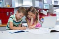 Siblings doing homework in kitchen Royalty Free Stock Photo