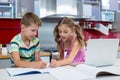 Siblings doing homework in kitchen Royalty Free Stock Photo