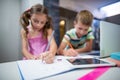 Siblings doing their homework in kitchen Royalty Free Stock Photo