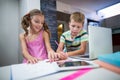 Siblings doing their homework in kitchen Royalty Free Stock Photo