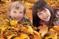 Siblings in fallen leaves Royalty Free Stock Photo