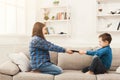 Siblings fighting over remote control at home Royalty Free Stock Photo