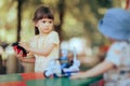 Stubborn Toddler Child Refusing to Share Toy with Her Brother Royalty Free Stock Photo