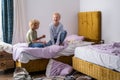 siblings having fun, laughing, boy and girl play pillow fight in messy childrens room, kids playing among the many toys Royalty Free Stock Photo