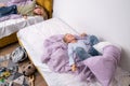 siblings having fun, laughing, boy and girl play pillow fight in messy childrens room, kids playing among the many toys Royalty Free Stock Photo