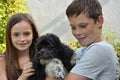 Siblings and her harlequin poodle