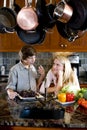 Siblings in kitchen chatting Royalty Free Stock Photo