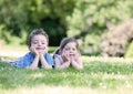 Siblings laying on the grass Royalty Free Stock Photo