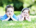 Siblings laying in the grass Royalty Free Stock Photo