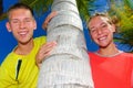 Siblings by palm tree Royalty Free Stock Photo