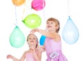 Siblings playing with balloons