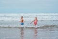 Siblings playing on beach, running, skipping, having fun. Smilling girl and boy on sandy beach of Canary islands Royalty Free Stock Photo