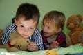 Siblings playing in the bedroom with their stuffed animals Royalty Free Stock Photo