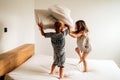 Siblings playing pillow fight on bed Royalty Free Stock Photo