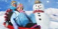 Siblings Playing Snow Sledge In The Snow Concept Royalty Free Stock Photo