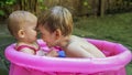 Siblings playing in a tub