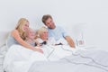 Siblings playing video games with parents watching Royalty Free Stock Photo