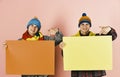 Siblings present autumn sale. Twin brothers in warm hats Royalty Free Stock Photo
