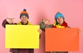 Siblings present autumn sale. Twin brothers in warm hats Royalty Free Stock Photo