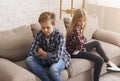 Siblings After Quarrel Sitting Back-To-Back On Couch At Home Royalty Free Stock Photo