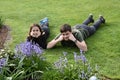 Siblings relaxing in garden Royalty Free Stock Photo