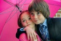 Siblings under pink umbrella Royalty Free Stock Photo