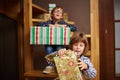 Siblings unwrapping Christmas presents