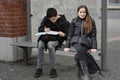 Siblings waiting at school bus stop