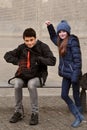 Siblings  waiting  at school bus stop Royalty Free Stock Photo