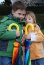 Brother and sister and big umbrellas Royalty Free Stock Photo