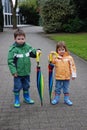 Brother and sister and big umbrellas