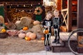 Siblings in the yard are celebrating Halloween. Children are happy cute beautiful wearing skeletons. Decoration for the holiday on