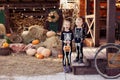 Siblings in the yard are celebrating Halloween. Children are happy cute beautiful wearing skeletons.