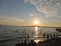 Sibolga , North Sumatra, Indonesia - January 11, 2022 : sunset on the Anggar beach and silhouettes of people on the beach Royalty Free Stock Photo