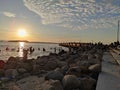 Sibolga , North Sumatra, Indonesia - January 11, 2022 : sunset on the Anggar beach and silhouettes of people on the beach Royalty Free Stock Photo