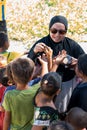 Visitors distributing snacks and goods to the Bajau Laut kids in their village