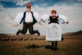 Sic Transilvania Romania 09.08.2018 Bride and groom in traditional suit on their wedding day jumping