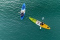 Unidentified two men on sea Kayaker Aerial View during sunset.