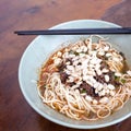 Sichuan style noodles like spicy noodle with chicken gizzard, minced, vegetables and peanut, Chinese cuisine