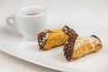 Sicilian Cannoli and coffee on white dish