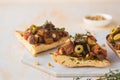 Sicilian caponata, eggplant, tomato and olive stew on white bread on a marble board against a light concrete background. Vegetable Royalty Free Stock Photo